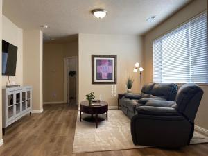 a living room with a couch and a table at Luxurious Condo at the Springs by Cool Properties in Mesquite