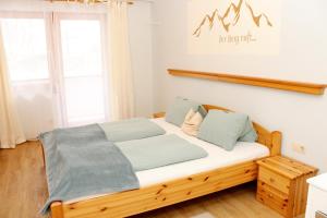 a bedroom with a wooden bed with blue pillows at Riverhaus in Schladming