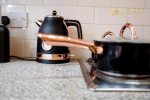 a tea kettle sitting on top of a stove at Luxury 2-bed Haven in Liverpool in Liverpool