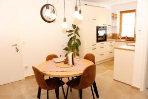 a kitchen and dining room with a wooden table and chairs at Riverhaus in Schladming