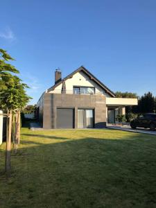 a house with a large lawn in front of it at Apartament Korczyńskiego 29 in Zakliczyn