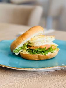 a sandwich on a plate on a table at Domki letniskowe Wiga in Kołobrzeg