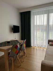a living room with a table and chairs and a couch at Apartament Korczyńskiego 29 in Zakliczyn
