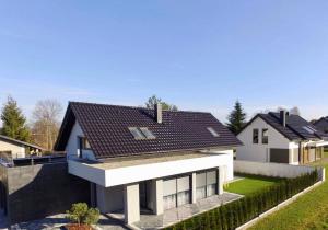 a white house with a black roof at Apartament Korczyńskiego 29 in Zakliczyn