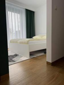 a bed in a room with a window at Apartament Korczyńskiego 29 in Zakliczyn