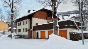 a house with snow on the ground in front of it at Riverhaus in Schladming