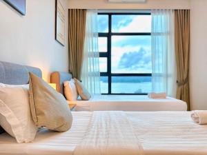 a hotel room with a bed and a window at #9 Jesselton Quay City Pads Seaview by Zeluxo in Kota Kinabalu