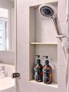 a bathroom with two bottles of soap on a shelf at #9 Jesselton Quay City Pads Seaview by Zeluxo in Kota Kinabalu
