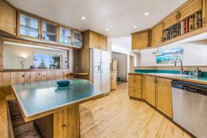 a large kitchen with wooden cabinets and a counter top at Hot Tub Pool Table Mountain Views Large Redwood Decks near Best Beaches Heavenly Ski Area and Casinos 9 in Stateline