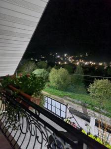 a balcony with a view of a city at night at S'Vitt in Skhidnitsa