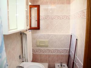 a bathroom with a sink and a toilet and a mirror at Holiday Home Blaž in Primošten