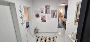 a hallway with white walls and photographs on the wall at Superior Apartment Lisinski - Private parking - 2 & 3 Bedroom in Zagreb +66 photos