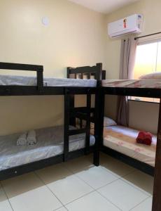 Una cama o camas cuchetas en una habitación  de Lençóis Dunas Residence 1
