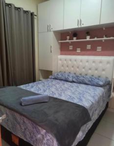 1 dormitorio con 1 cama con cabecero blanco en Lençóis Dunas Residence 1 en Santo Amaro