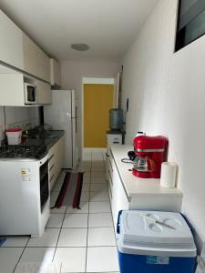 a kitchen with a red appliance on a counter at Neo 2.0 in Maceió