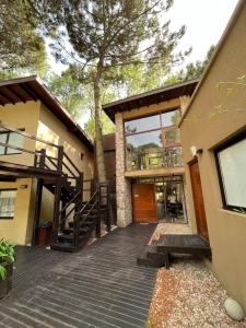 une maison avec un escalier menant à un arbre dans l'établissement Complejo Agapanto, à Mar de las Pampas