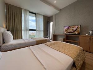 um quarto de hotel com duas camas e uma janela em İNNPORT HOTEL em Gebze
