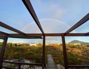 a view from the inside of a building with a window at Brandys beach house bettys bay in Bettyʼs Bay
