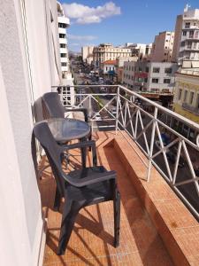 a balcony with a table and a chair on a balcony at Piraeus Acropole Hotel in Piraeus