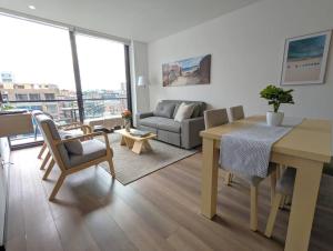a living room with a table and a couch at Stylish 2 bedroom near Parque 93. FREE Parking. in Bogotá