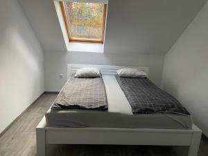 łóżko w pokoju z oknem w obiekcie Yacht Club Apartamenty w mieście Radzyń