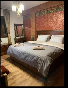 a bedroom with a large bed with two trays on it at Vila IRA in Veria