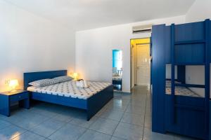 a bedroom with a blue bed and a bunk room at Stegna-TULA in Archangelos