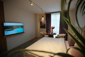 a hotel room with a bed and a tv on a wall at Vanilla 11 in Istanbul
