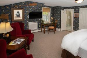 a bedroom with a bed and a living room at The Dorset Inn in Dorset