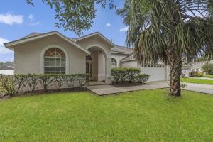 a house with a palm tree in a yard at OT16029BH - 6 bedrooms - 12 guests in Orlando