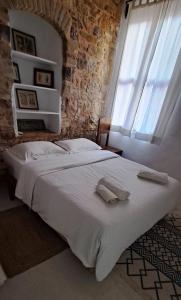 een slaapkamer met een bed met twee handdoeken erop bij THE GARDEN OF CHIOS in Chios