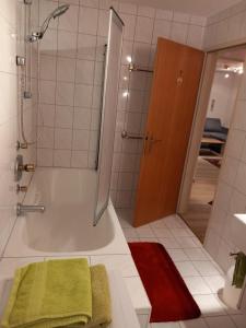 a bathroom with a shower and a tub with a green towel at Landhaus-Königsberg, Vorberg 360 Ebengütlweg in Ramsau am Dachstein +87 photos