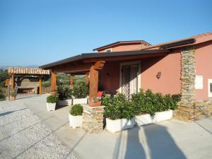 a house with potted plants in front of it at Case Vacanze Longo in Balestrate
