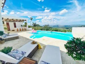a villa with a swimming pool with a view at Beautiful villa with pool in San Felipe de Puerto Plata