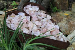 two containers filled with pink rocks next to some grass at Livingstone Villa in Wilderness