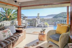 a living room with a view of the ocean at Livingstone Villa in Wilderness