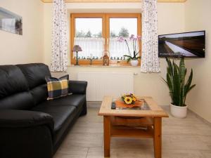 a living room with a black couch and a coffee table at Apartment house, Lütow in Lütow