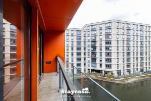 a view of a building from a balcony at Luxury Haven Double Balcony Apt With Canal View in Manchester
