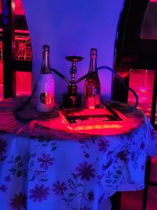 a table with two bottles and a lamp on it at Big Apple Hotel in Montego Bay