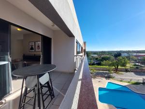 a balcony with a table and chairs and a view at Diseño, Confort, 3Dorm + 3Baños in San Lorenzo de la Frontera