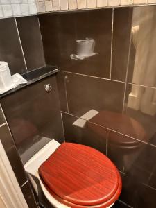 a bathroom with a red toilet with a red lid at Luxury city centre Apartment in London