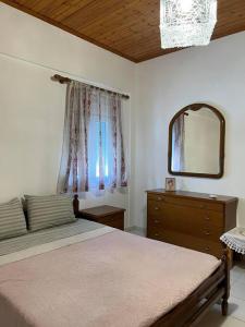 a bedroom with a bed and a dresser and a mirror at TRADITIONAL HOUSE IN THE VILLAGE 