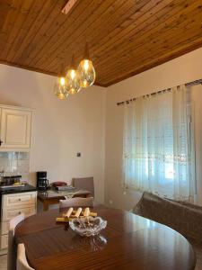 a dining room with a table and a kitchen at TRADITIONAL HOUSE IN THE VILLAGE 