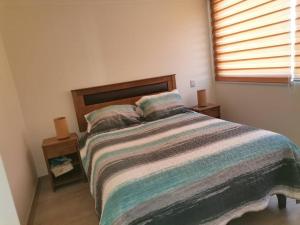 En eller flere senge i et værelse på Departament La Serena faro 2D2B + 3 billeder