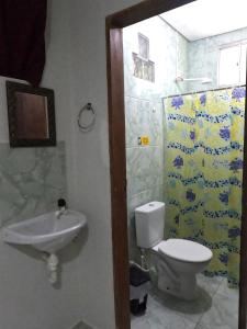 a bathroom with a toilet and a sink at Flat Japaratinga Beach in Japaratinga +49 photos