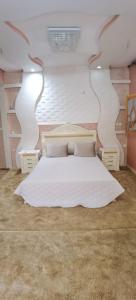 a bedroom with a large white bed in a room at Riad Khadija: Relax & Explore in Taroudant