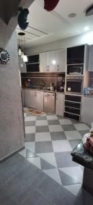 a large kitchen with a checkered floor at Riad Khadija: Relax & Explore in Taroudant