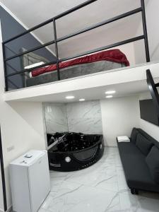 a loft bed with a car in a room at LUIGI LUXURY SUITE in Naples