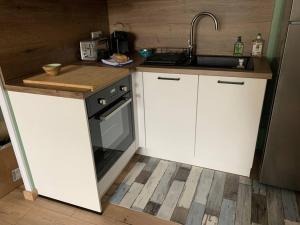 a kitchen with a sink and a stove at Charment Appartement Duplex - Pornichet in Pornichet +3 photos