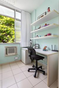 an office with a desk and a chair and a window at Studio SOL de COPACABANA 300 m da Praia in Rio de Janeiro